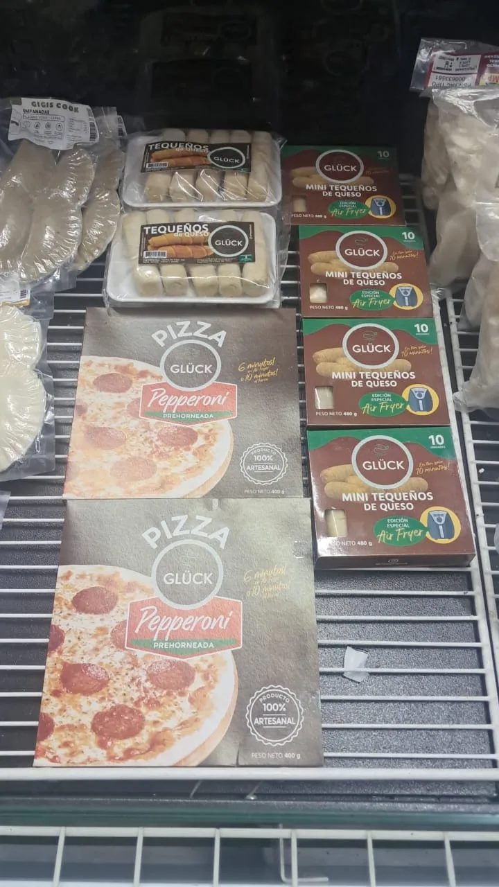 Tiefkühlregal in einem Supermarkt mit Pizzen und Tequeños von Glück
